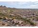 Expansive aerial view of a desert neighborhood with mountain views, golf course, and beautiful homes at 5217 S Crested Saguaro Ln, Gold Canyon, AZ 85118