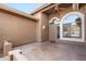 Inviting front porch features textured tile, neutral stucco, and a decorative arched window offering ample natural light at 5217 S Crested Saguaro Ln, Gold Canyon, AZ 85118