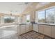 Bright kitchen featuring stainless steel appliances, tile countertops, and large windows with shutters at 5217 S Crested Saguaro Ln, Gold Canyon, AZ 85118