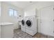 Functional laundry room with a washer, dryer, storage cabinets and a sink at 5217 S Crested Saguaro Ln, Gold Canyon, AZ 85118