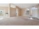 Open-concept living room with neutral tones, tile accents, and a seamless flow into the kitchen area at 5217 S Crested Saguaro Ln, Gold Canyon, AZ 85118