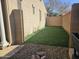 Artificial turf backyard with a rock border at 6354 S Sinova Ave, Gilbert, AZ 85298