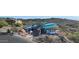 Aerial view of a modern house under construction, showcasing its unique design and surrounding landscape at 9609 N Palisades Blvd, Fountain Hills, AZ 85268