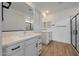 Bright bathroom with double vanity, framed mirrors, and a glass-enclosed shower at 17316 W Via Dona Rd, Surprise, AZ 85387