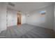 Spacious bedroom featuring neutral carpeting, ensuite bathroom, and ample natural light at 17316 W Via Dona Rd, Surprise, AZ 85387