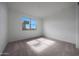 Neutral bedroom with carpet, white walls, window view, and ready for personalization at 17316 W Via Dona Rd, Surprise, AZ 85387