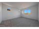 Well-lit bedroom featuring plush carpeting and multiple windows for ample natural light at 17316 W Via Dona Rd, Surprise, AZ 85387