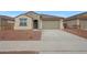 Charming single-story home with a tile roof, two-car garage, and low maintenance desert landscaping at 17316 W Via Dona Rd, Surprise, AZ 85387