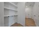 Hallway with a coat rack, shelving and views of interior doors and wood-look floors at 17316 W Via Dona Rd, Surprise, AZ 85387