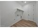 Laundry room with storage space and a view of a door, light switches, and floor at 17316 W Via Dona Rd, Surprise, AZ 85387