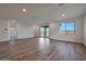 Bright living room with wood-style tile floor, recessed lighting, and sliding glass doors to the backyard at 17316 W Via Dona Rd, Surprise, AZ 85387