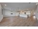 Spacious open-concept living area featuring modern kitchen, wood-style tile floor, and recessed lighting at 17316 W Via Dona Rd, Surprise, AZ 85387