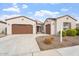 Two-car garage, desert landscaping, and neutral color scheme at 214 E Taurus Pl, Chandler, AZ 85249