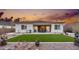 Artificial turf backyard with a patio and fire pit at 2453 N 211Th Ln, Buckeye, AZ 85396