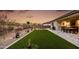 Artificial turf backyard with a patio and built-in grill at 2453 N 211Th Ln, Buckeye, AZ 85396
