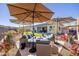 Backyard with seating area, artificial turf, and umbrellas at 2453 N 211Th Ln, Buckeye, AZ 85396