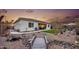 Backyard with a wooden bridge, artificial turf, and desert landscaping at 2453 N 211Th Ln, Buckeye, AZ 85396