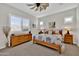 Spacious bedroom with wood furniture and a ceiling fan at 2453 N 211Th Ln, Buckeye, AZ 85396