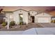 House exterior showcasing a two-car garage and desert landscaping at 2453 N 211Th Ln, Buckeye, AZ 85396