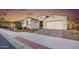Stunning two-story home with a three-car garage and landscaped front yard at 2453 N 211Th Ln, Buckeye, AZ 85396