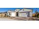 Single story home with white exterior, two-car garage and landscaped front yard at 2453 N 211Th Ln, Buckeye, AZ 85396