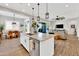 Open concept kitchen with large island, stainless steel appliances, and breakfast bar at 2453 N 211Th Ln, Buckeye, AZ 85396