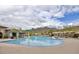 Community pool with a water feature and seating area at 2453 N 211Th Ln, Buckeye, AZ 85396