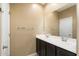 Bright bathroom with double vanity and a large mirror at 41369 W Crane Dr, Maricopa, AZ 85138