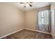 Well-lit bedroom with ceiling fan and patterned curtains at 41369 W Crane Dr, Maricopa, AZ 85138