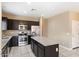 Modern kitchen with dark wood cabinets, granite countertops, and stainless steel appliances at 41369 W Crane Dr, Maricopa, AZ 85138