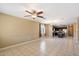 Open living room and kitchen with tile floors and neutral walls at 41369 W Crane Dr, Maricopa, AZ 85138