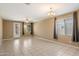 Living room with tile floors, sliding door to patio, and neutral decor at 41369 W Crane Dr, Maricopa, AZ 85138