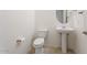 Bright half bathroom featuring pedestal sink, tile floor, and neutral color scheme at 5531 W Gwen St, Laveen, AZ 85339
