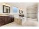 Spacious primary bathroom featuring dual vanities, soaking tub, and glass enclosed shower at 5531 W Gwen St, Laveen, AZ 85339