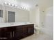 Elegant bathroom features a dual sink vanity, framed mirror, and a shower-over-tub combination at 5531 W Gwen St, Laveen, AZ 85339