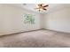Inviting bedroom with plush carpeting, ceiling fan, and window offering views at 5531 W Gwen St, Laveen, AZ 85339