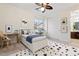 This neutral bedroom features a ceiling fan, a study desk, and creative decor at 5531 W Gwen St, Laveen, AZ 85339