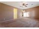 Bright bedroom with ceiling fan and access to bathroom at 5531 W Gwen St, Laveen, AZ 85339