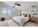 Neutral bedroom features a ceiling fan, accent lighting, and natural decor at 5531 W Gwen St, Laveen, AZ 85339