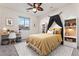 This cheerful bedroom features a ceiling fan, study desk, and creative decor at 5531 W Gwen St, Laveen, AZ 85339