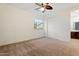 Bright bedroom features carpet floors, a ceiling fan, and a large window for natural light at 5531 W Gwen St, Laveen, AZ 85339