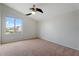This cozy bedroom offers a ceiling fan, neutral carpet, and a window that frames scenic views at 5531 W Gwen St, Laveen, AZ 85339