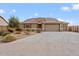 Beautiful two-story home with a three-car garage and desert landscaping at 5531 W Gwen St, Laveen, AZ 85339