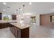 Open-concept kitchen with island and granite countertops which flows into the dining area with backyard access at 5531 W Gwen St, Laveen, AZ 85339