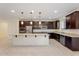 A spacious kitchen features granite countertops, stainless steel appliances, and a large island at 5531 W Gwen St, Laveen, AZ 85339