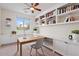 A home office features custom built-ins, a ceiling fan, and natural lighting at 5531 W Gwen St, Laveen, AZ 85339