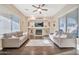 Living room with hardwood floors, fireplace, and large windows at 13653 W Jesse Red Dr, Peoria, AZ 85383