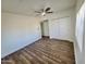 Spacious bedroom featuring wood floors, ceiling fan, and double door closet at 2112 N 24Th Pl, Phoenix, AZ 85008