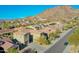 Aerial view of house and neighborhood with mountain backdrop at 27486 N 89Th Dr, Peoria, AZ 85383