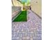 Brick paved backyard with a small lawn area at 27486 N 89Th Dr, Peoria, AZ 85383
